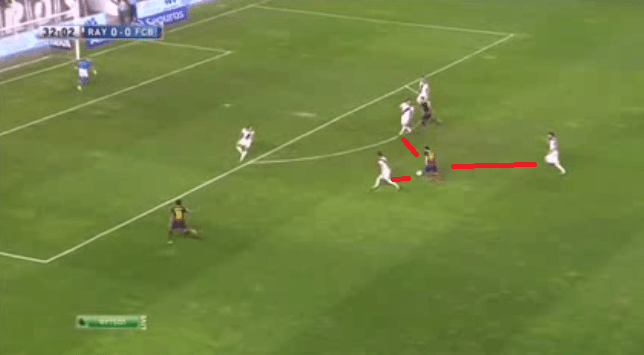 Three Rayo Players trying to get the Ball from Messi